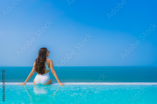 Portrait beautiful young asian woman happy smile relax in swimming pool for travel vacation