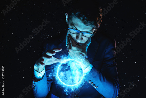 Billede på lærred Man businessman holding hands over a blue glowing plasma sphere