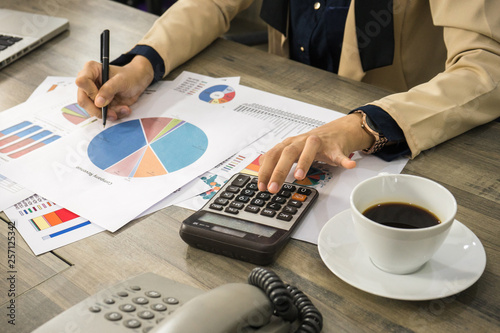 Business woman are planning profit by look at the chart diagram and calculate for finish