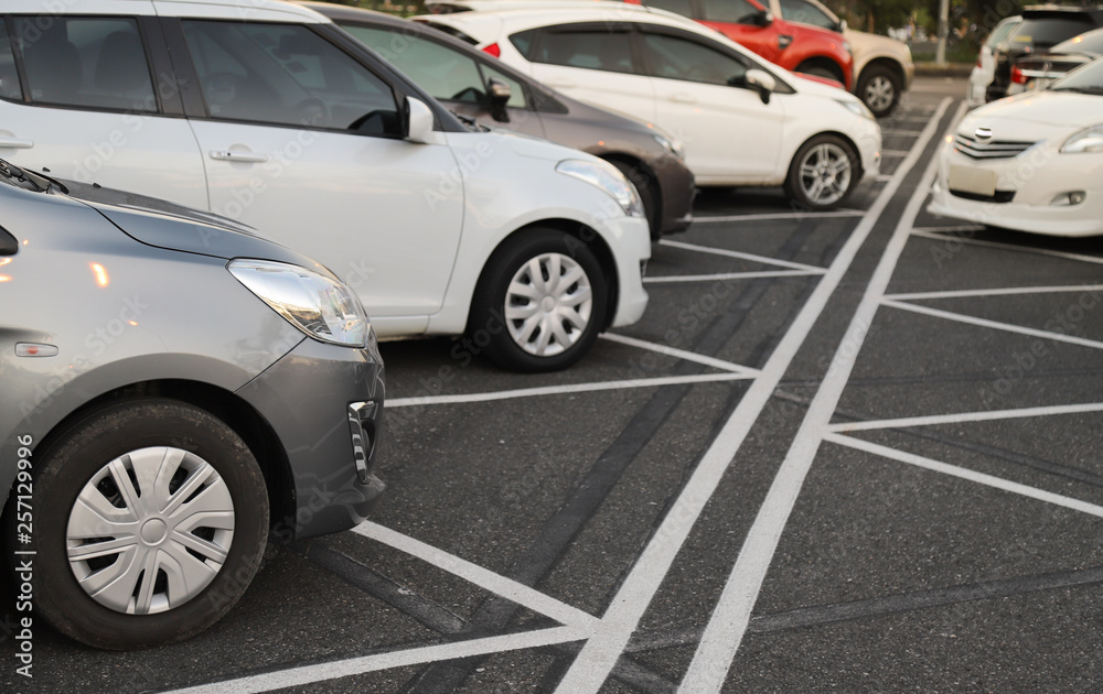 Closeup of front side of cars parking in parking area in opposite direction in twilight evening. Closeup of front side of cars parking in parking area in opposite direction in twilight evening.