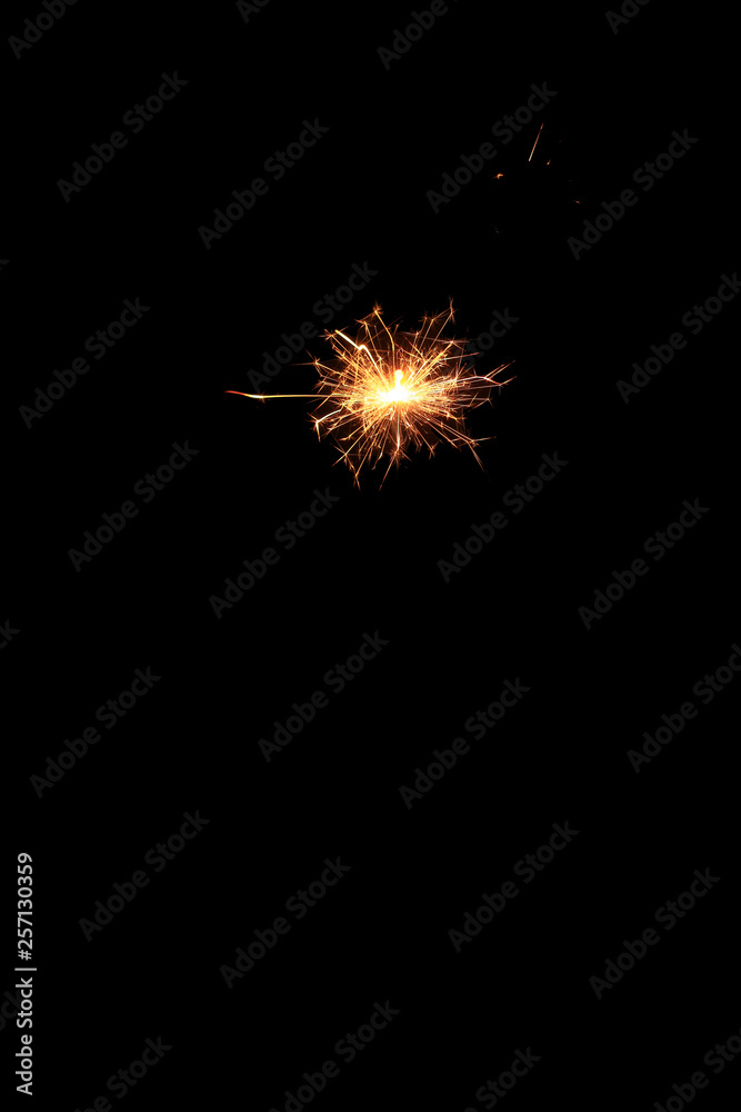 Fototapeta premium yellow sparks on a black background