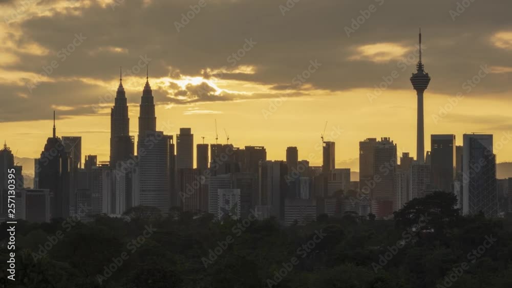 Sun setting scenery against Kuala Lumpur skyscraper, dramatic clouds moving. 4k UHD time lapse footage with zoom in camera effect. Sun setting scenery against Kuala Lumpur skyscraper, dramatic clouds moving. 4k UHD time lapse footage with zoom in camera effect.
