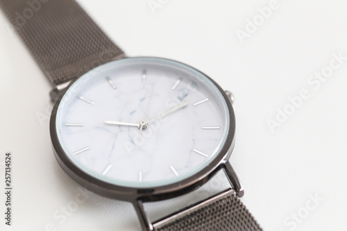 Close up of a classic watch in a white background.