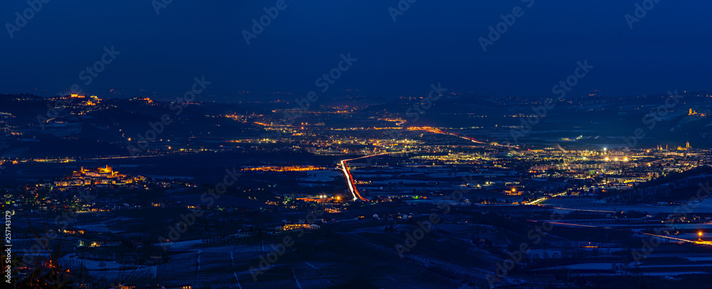 Panorama of Langhe near Alba city in winter at blue hour