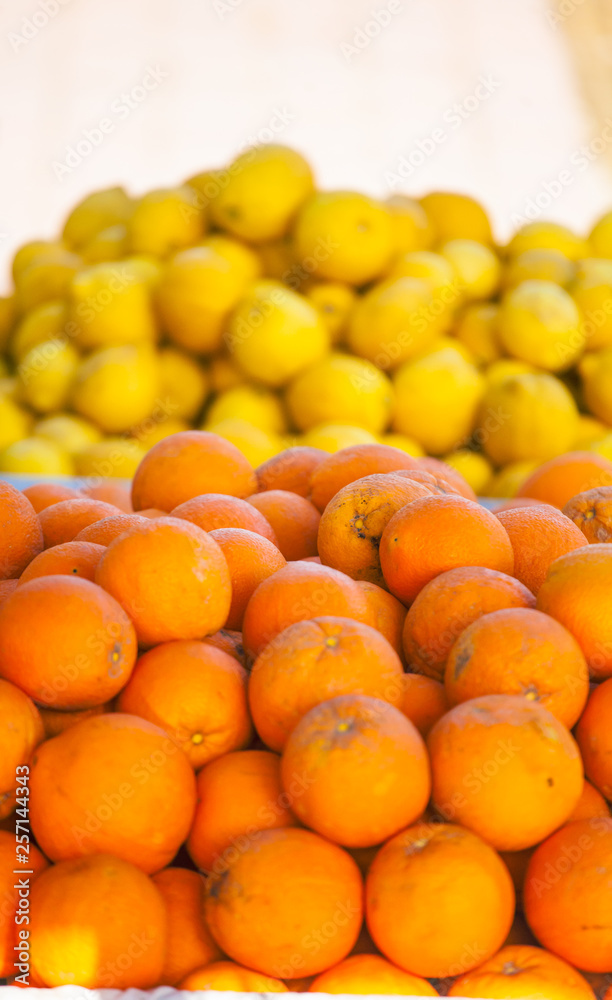 Fresh oranges and lemons close up.