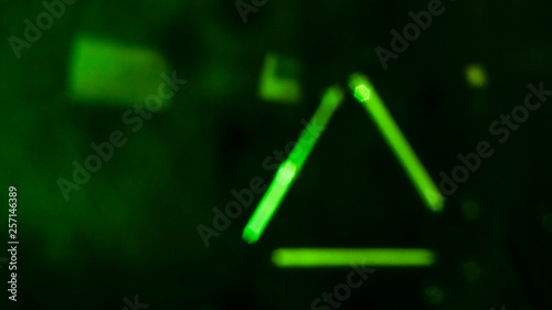 Green futuristic lines and shapes on black background