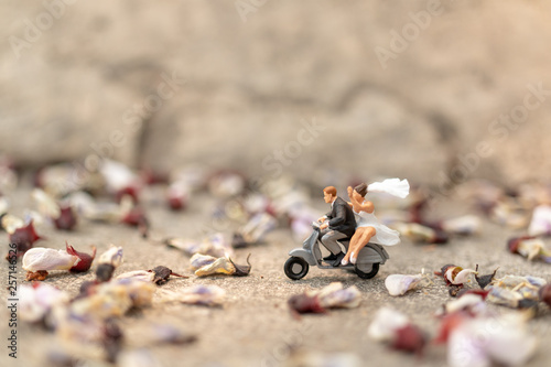 Miniature people : Couple riding the motorcycle in the garden  , Valentine's Day concept © Sirichai Puangsuwan