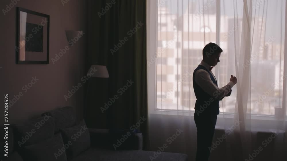 Buttoning a suit. Stylish man in a suit fastening buttons on his suit preparing to go out. Close up Buttoning a suit. Stylish man in a suit fastening buttons on his suit preparing to go out. Close up