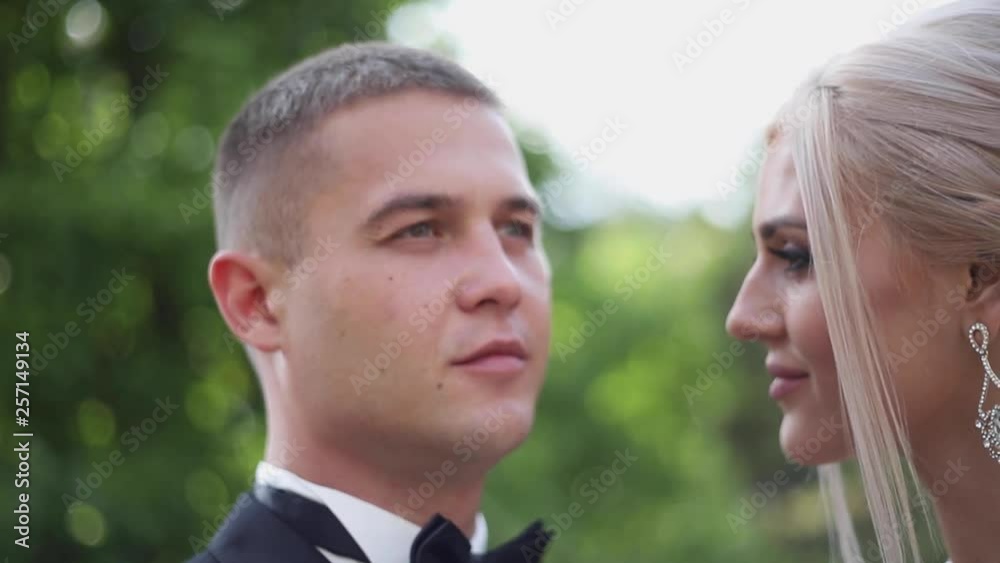 Close up of groom and bride. Beautiful wedding couple in the park. Stylish newlyweds