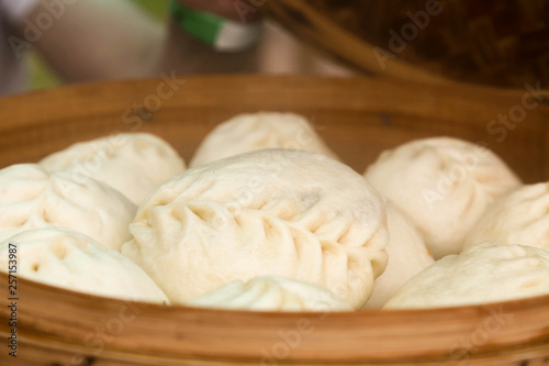 Steamed Korean dumplings Mandu with chicken meat and vegetables in a bamboo steamer