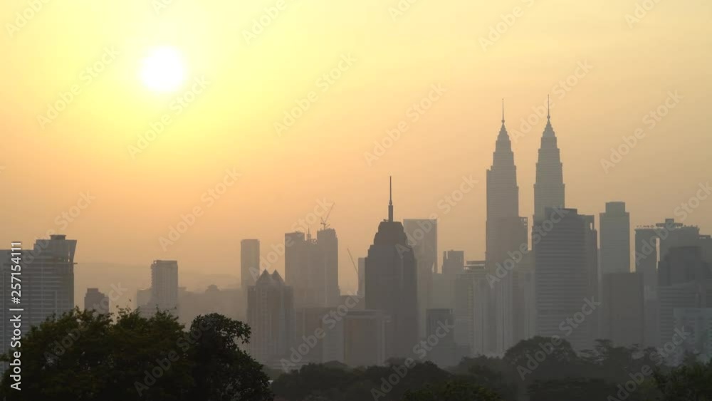 4k UHD establishing cinematic b-roll shot of sunrise scene at Kuala Lumpur city skyline during hazy and misty season. 4k UHD establishing cinematic b-roll shot of sunrise scene at Kuala Lumpur city skyline during hazy and misty season.