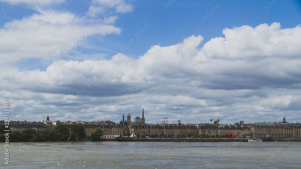 City of Bordeaux under clouds over Garonne River, in Bordeaux, France