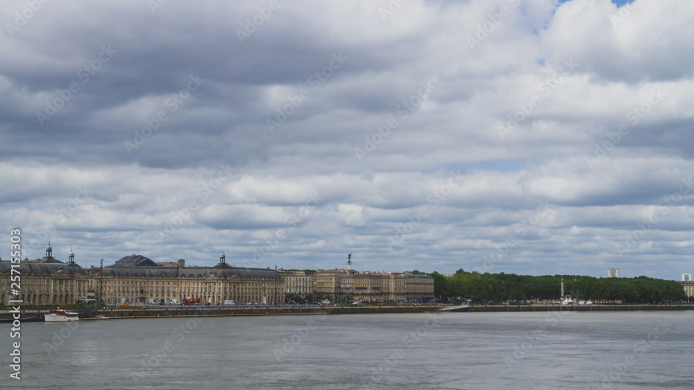 City of Bordeaux under clouds over Garonne River, in Bordeaux, France