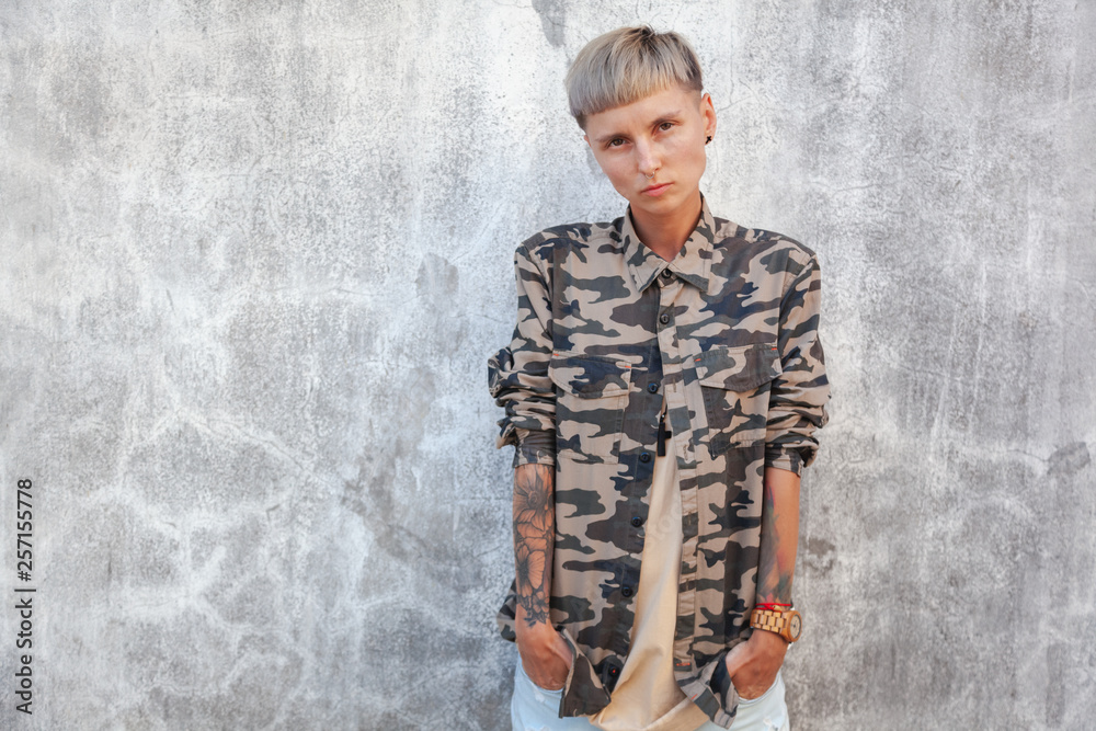 Stylish young European woman brutal with short haircut, rebel, a variety of people