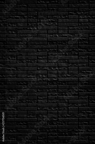 Abstract black brick wall texture background. Vertical view of masonry brick wall.
