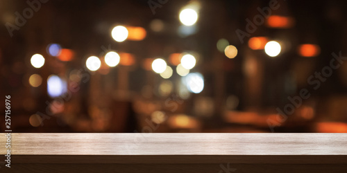 Empty wooden table top with blur coffee shop or restaurant interior background  Panoramic banner. Abstract background can be used for display or montage your products.