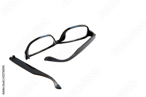 Broken eye glasses, isolated on white background. Black celluloid frame.