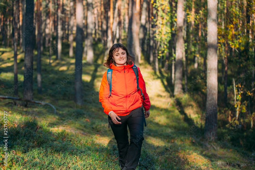 Active Young Beautiful CaucasianLady  Woman Dressed In Red Jacket Walking In Autumn Forest. Active Lifestyle In Fall Age Nature