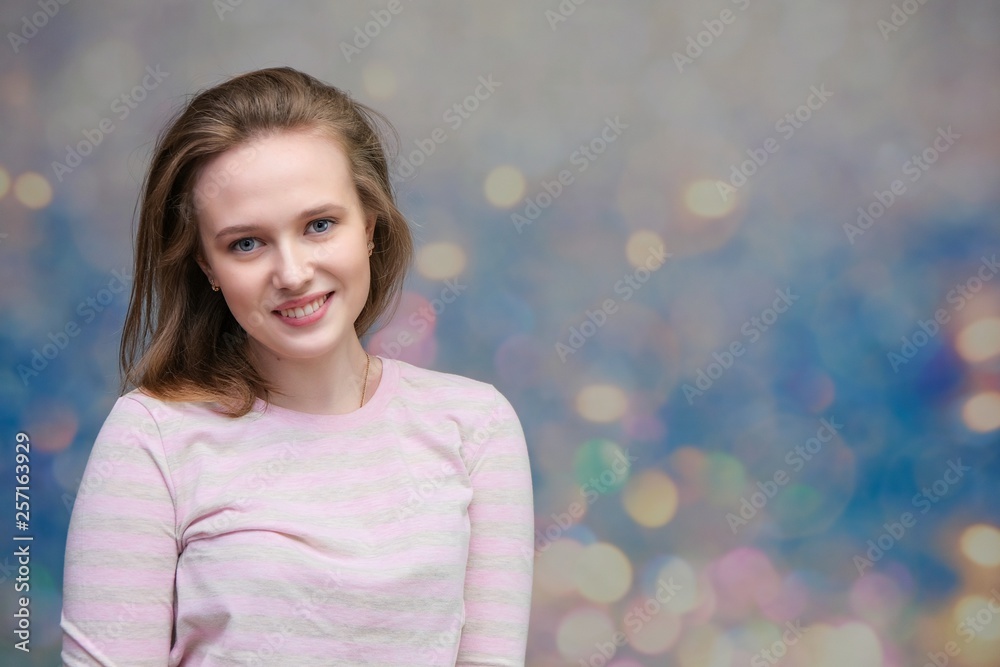 portrait of soncept young cheerful long-haired loving brunette woman standing in casual clothes, shaking hair and talking on a colored background.