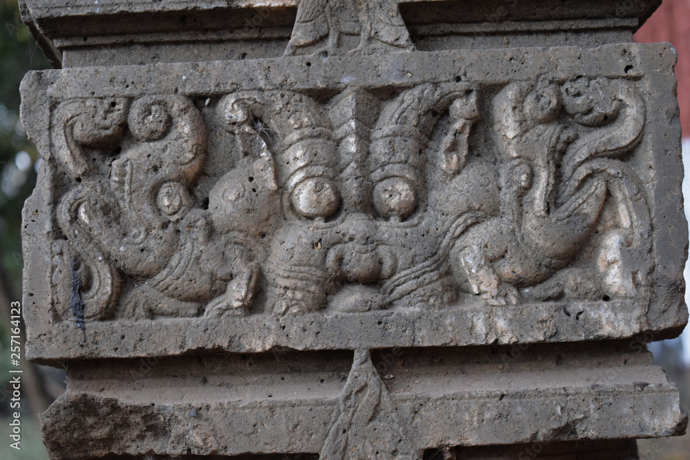 ancient ruined stone carving of Hindu god in the old city of India