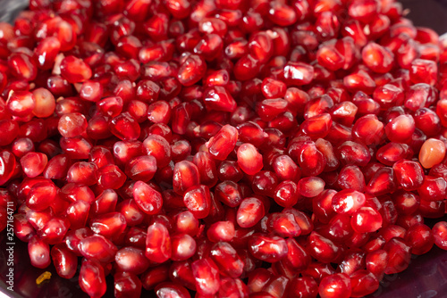red ripe pomegranate seeds on a plate close-up. pomegranate fruit. healthy diet