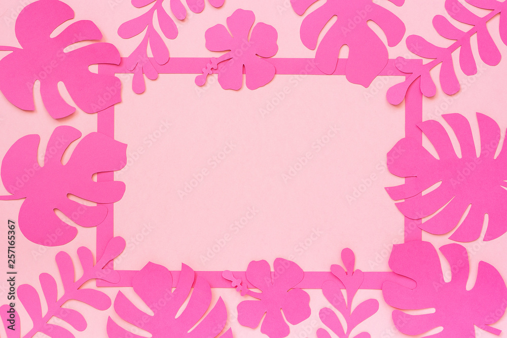 Tropical leaves pattern. Trendy tropical leaves of paper and frame on pink background. Template for text or your design. Flat lay, top-down composition, creative paper art