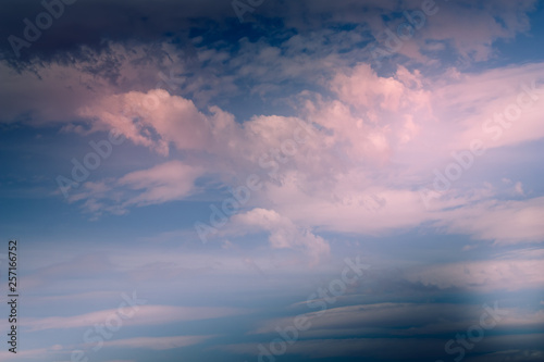 Dramatic blue sky with pink cumulus, lenticular and cirrus clouds