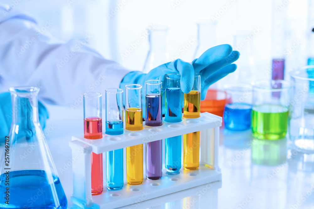 scientist with equipment and science experiments, laboratory glassware containing chemical liquid for research or analyzing a sample into test tube in laboratory scientist with equipment and science experiments, laboratory glassware containing chemical liquid for research or analyzing a sample into test tube in laboratory