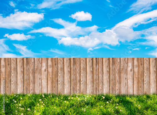 Wooden garden fence at backyard and blue sky with white clouds
