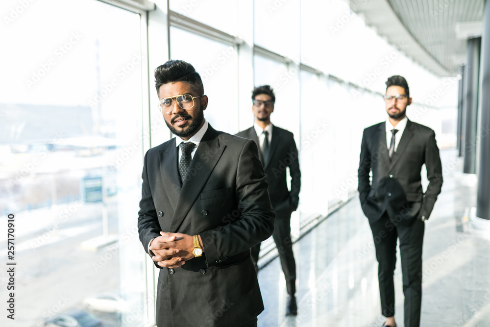 Portrait of three happy success handsome business man walk and talk. Teamwork friendship business people entrepreneur partnership greeting brainstorm success gay concept Portrait of three happy success handsome business man walk and talk. Teamwork friendship business people entrepreneur partnership greeting brainstorm success gay concept