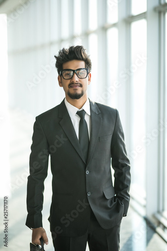 Portrait of indian businessman Standing By Window In Office