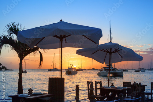 Beautiful sunset on the sea beach cafe or restaurant  boats  ships and yachts on water background