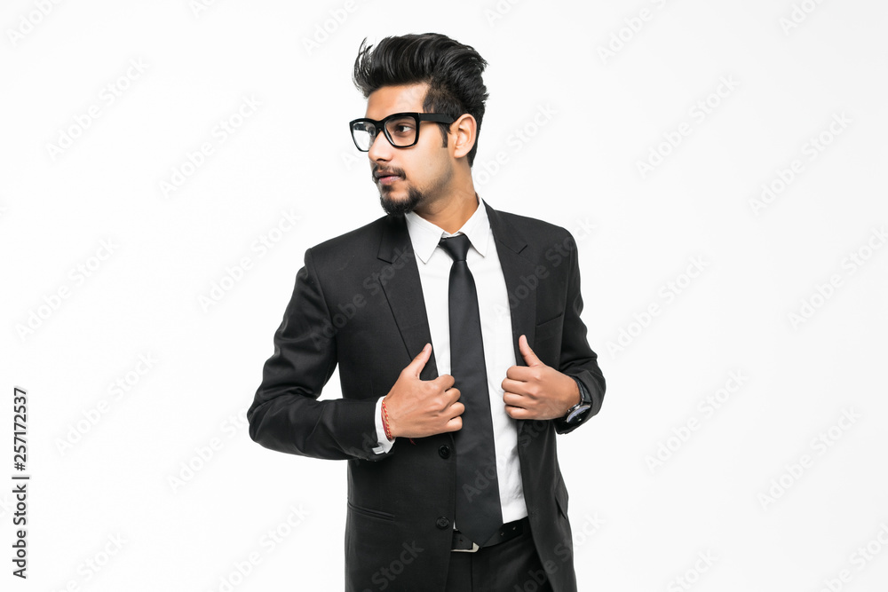 Happy handsome young indian businessman standing confidently isolated on white background Happy handsome young indian businessman standing confidently isolated on white background