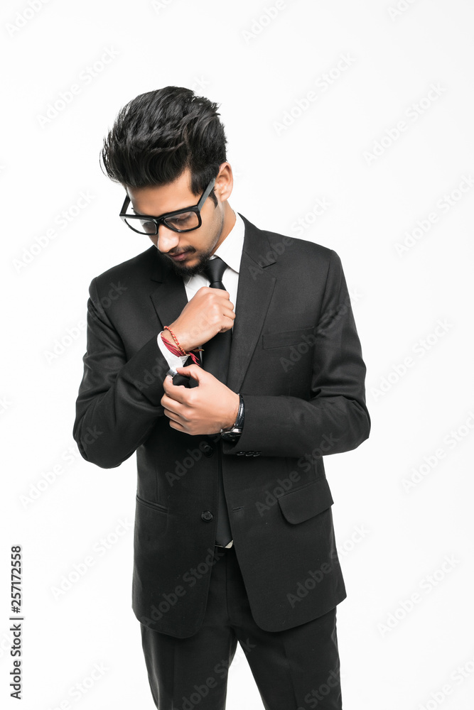 Portrait of a serious indian businessman standing isolated on a white background. Portrait of a serious indian businessman standing isolated on a white background.