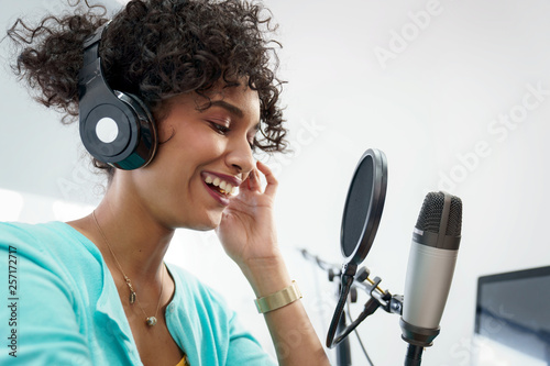 Attractive African American Young Woman Doing Online Podcast With Microphone