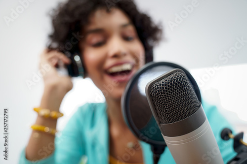 Attractive African American Young Woman Doing Online Podcast With Microphone