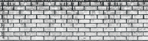 Wide old white shabby brick wall texture. Light gray aged masonry panorama. Whitewashed brickwork panoramic grunge background