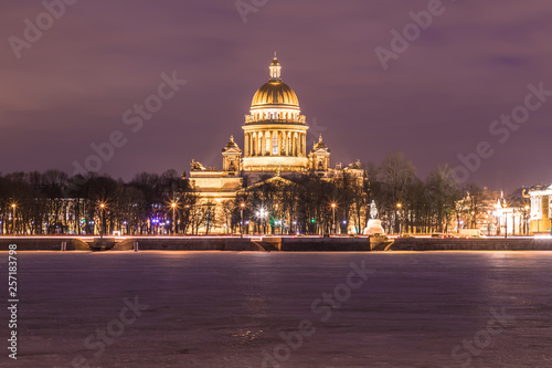Neva river under the ice and snow and Beautiful Saint Isaac's Cathedral or Isaakievskiy Sobor in Saint Petersburg, Russia