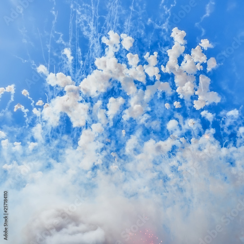 sky of valencia during a mascleta in the festival of fallas. Thousands of pyrotechnic elements called masclets, explode every day during the festivities filling the city with smoke and color.  photo