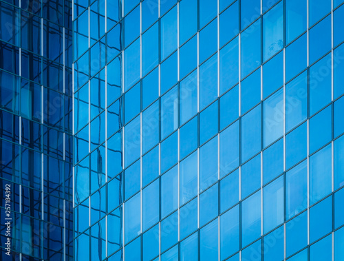 Glass of modern tower for business background, blue tone