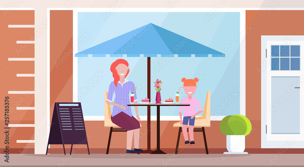 mother with daughter sitting modern summer cafe drinking cocktails and eating cakes street restaurant terrace outdoor cafeteria exterior flat horizontal full length