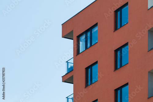 Photo of a new modern residential building with blue sky.