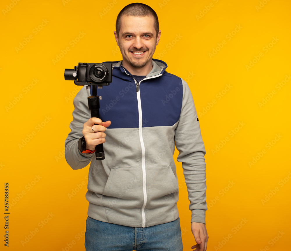 Man videographer or blogger with camera on gimbal Man videographer or blogger with camera on gimbal