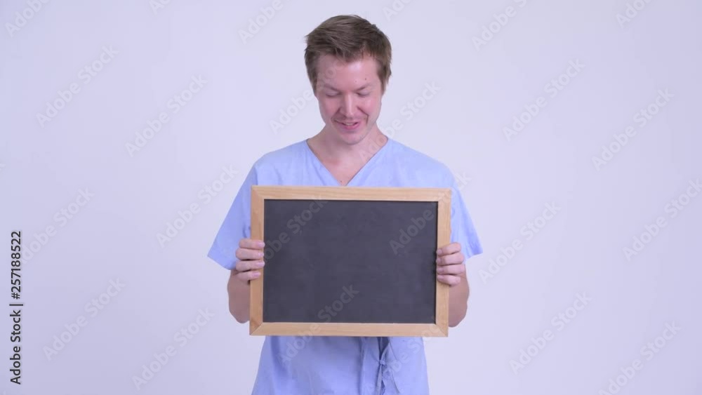 Portrait of happy young man patient holding blackboard Portrait of happy young man patient holding blackboard