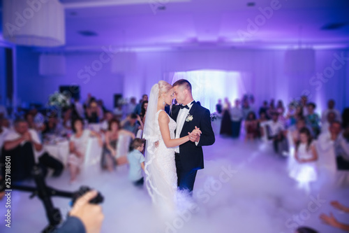 First dance of stylish wedding couple. Handsome groom and elegant bride in the restaurant