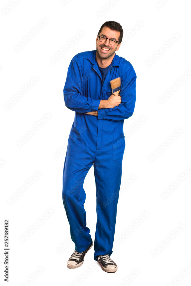 A full-length shot of a Painter man keeping the arms crossed while smiling on isolated white background A full-length shot of a Painter man keeping the arms crossed while smiling on isolated white background