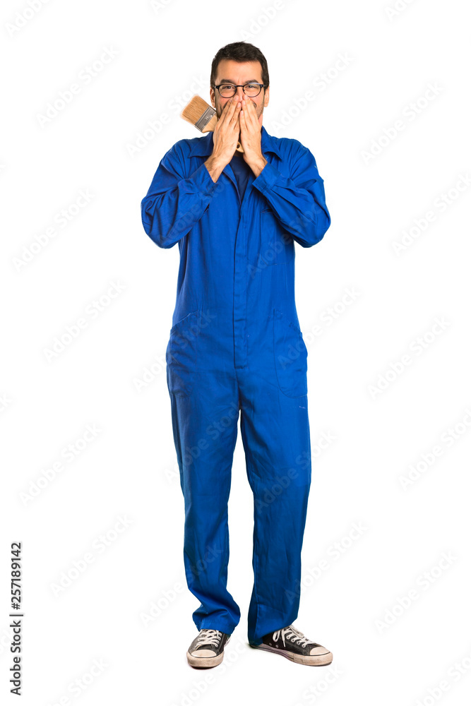 A full-length shot of a Painter man smiling a lot while covering mouth on isolated white background A full-length shot of a Painter man smiling a lot while covering mouth on isolated white background