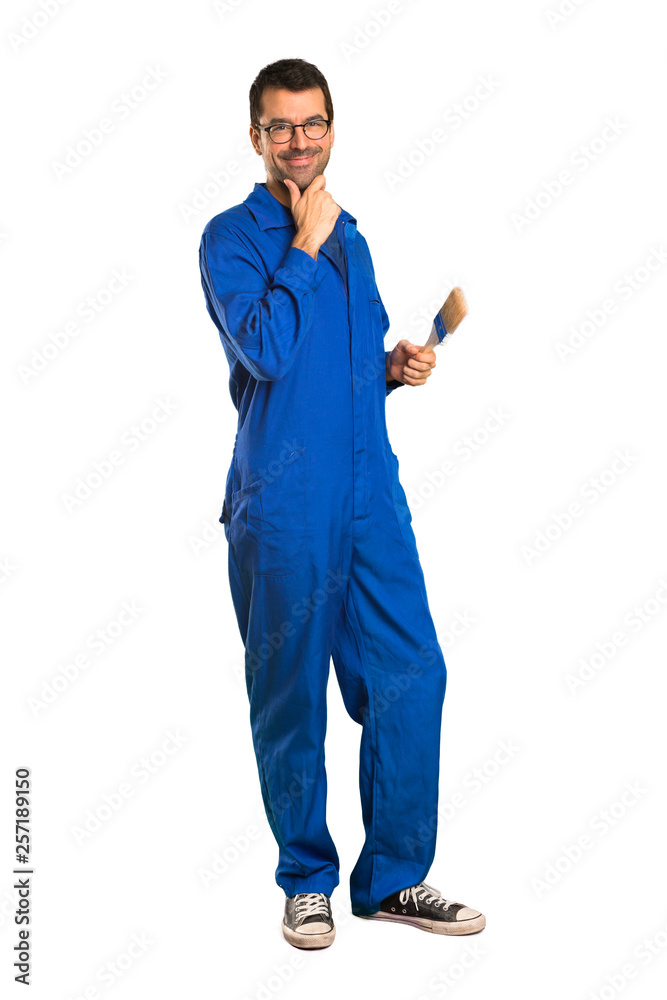 A full-length shot of a Painter man smiling with a sweet expression on isolated white background A full-length shot of a Painter man smiling with a sweet expression on isolated white background