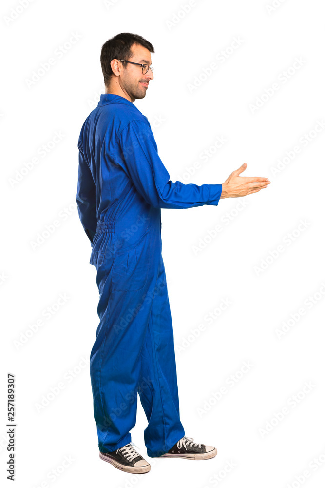 A full-length shot of a Painter man handshaking after good deal on isolated white background