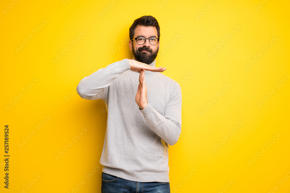 Man with beard and turtleneck making stop gesture with her hand to stop an act